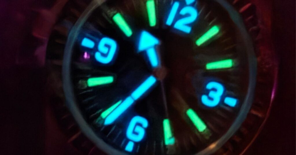 Macro view of the Phorcydes PH-4B dial highlighting the unique 3D Hyperglow block indices, white minute track, and orange-tipped second and minute hands.