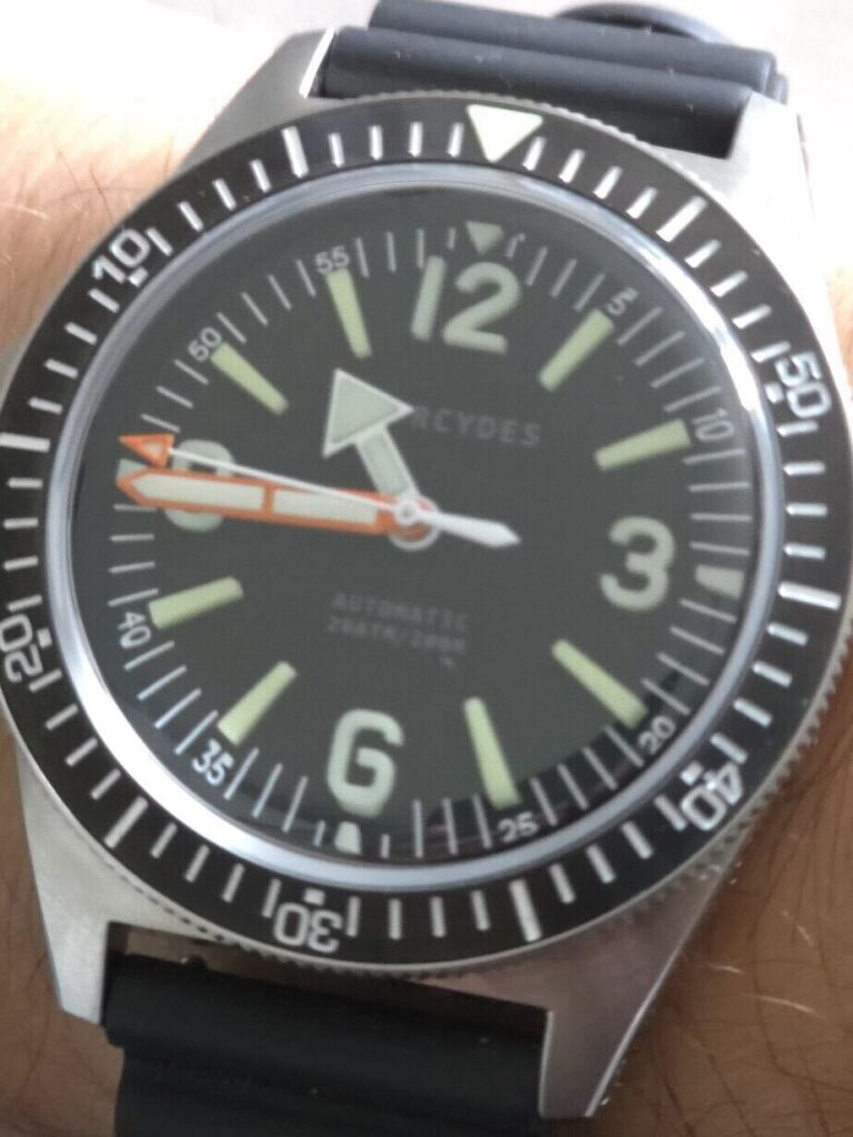 Studio angle shot of the Phorcydes PH-4B skin diver, showcasing its domed sapphire crystal and the 9 o'clock crown position.