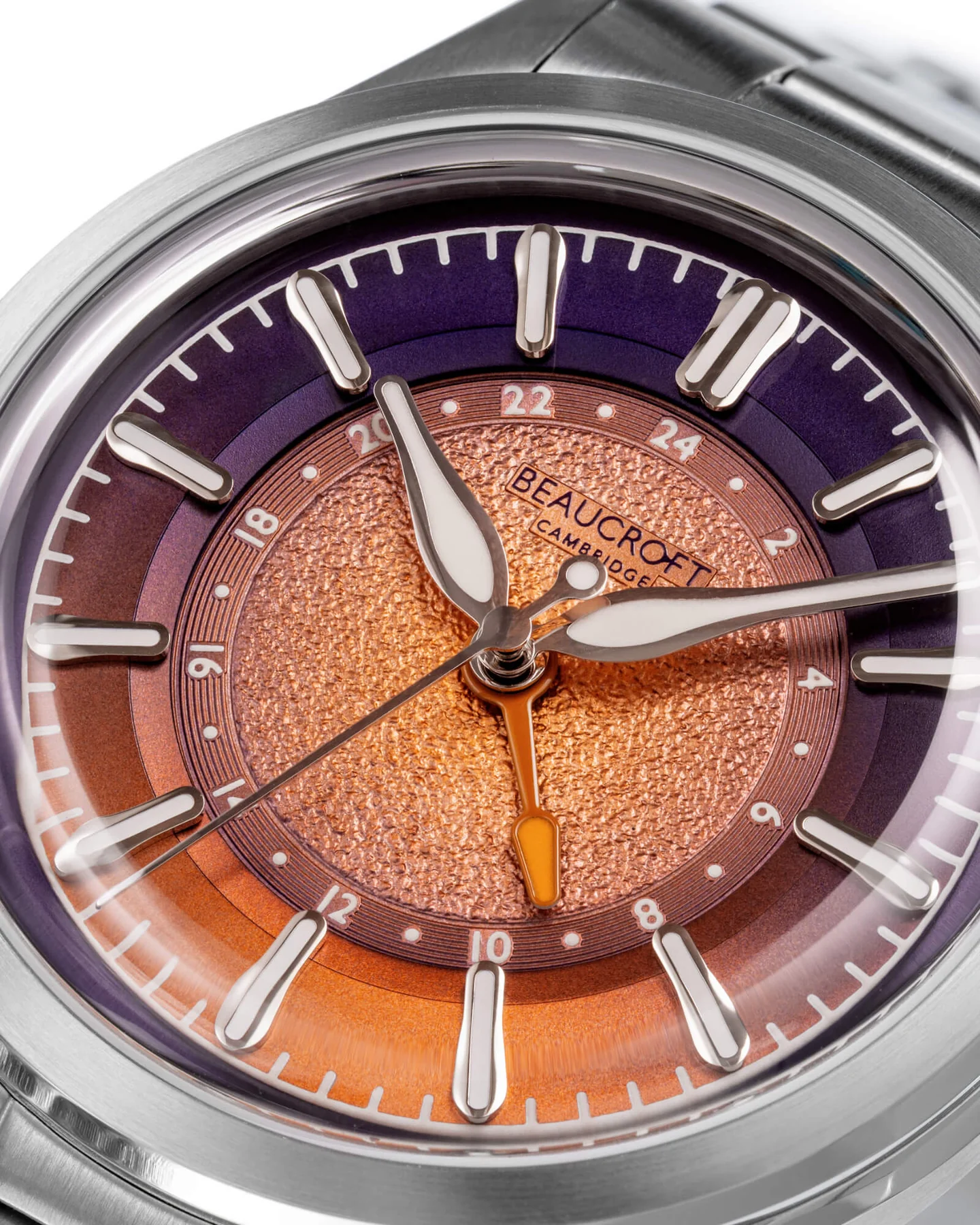 Beaucroft Macro close-up shot of a Beaucroft Cambridge Solaris GMT watch face featuring a textured copper center dial, a two-tone orange and purple 24-hour ring, and an orange GMT hand.