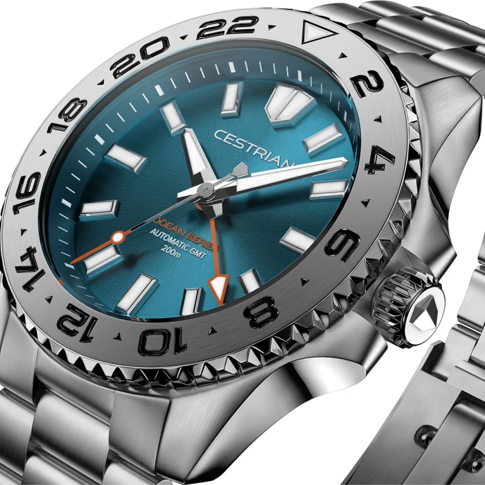 Close-up angled studio render of the Cestrian Ocean Series GMT automatic watch showcasing a vibrant blue gradient dial, 24-hour rotating bezel, orange GMT hand, and stainless steel case and bracelet.