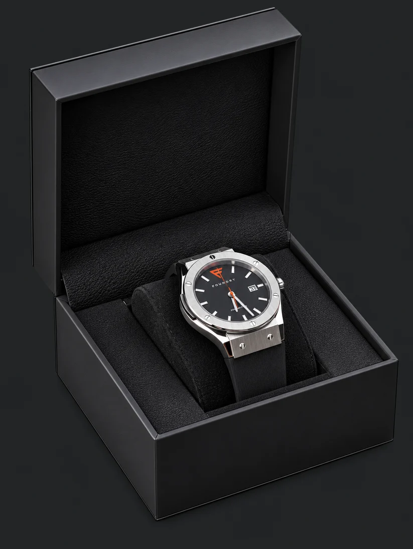 Foundry Watch Co. The Foundry Foreman 45 watch displayed inside its open black matte presentation box, resting on a black cushion.