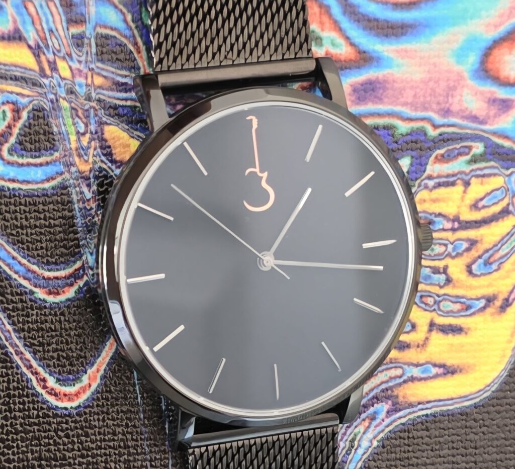 Luthier Front view of the minimalist Luthier LP Black watch face with silver hands and rose gold guitar logo.