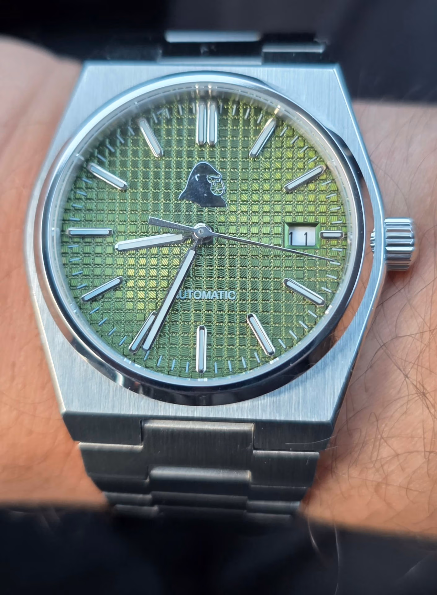 Review: Silverback Watches Interceptor Silverback Interceptor sage green dial catching the light, showing the date window at 3 o’clock and “AUTOMATIC” text at 6 o’clock