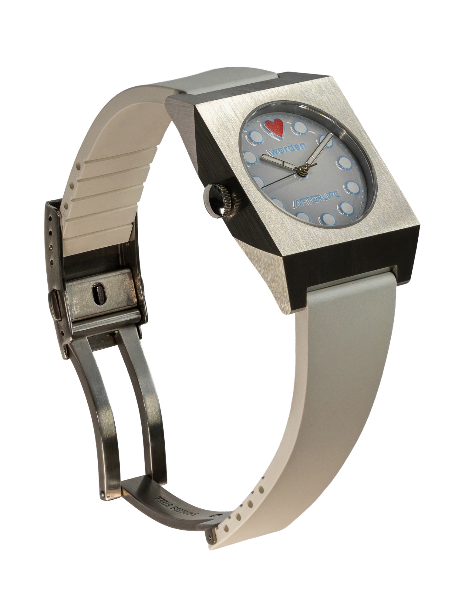 Worden Watches Angled view of a Worden Watch Studio "Afterlife" watch featuring an angular brushed stainless steel case, light grey dial with light blue dot indices, red heart marker at 12 o'clock, and off-white rubber strap with deployant clasp.